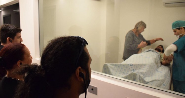 The instructor observes and listens to a scenario bettering communication skills