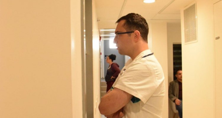 The trainee awaits instruction to enter training room